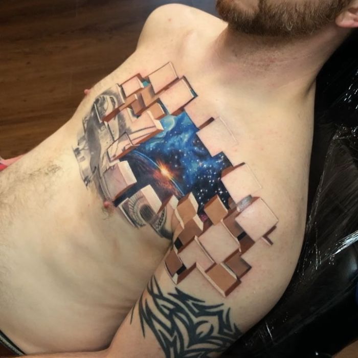 3D tattoo on a man's chest featuring a space and geometric design, creating a lifelike illusion.