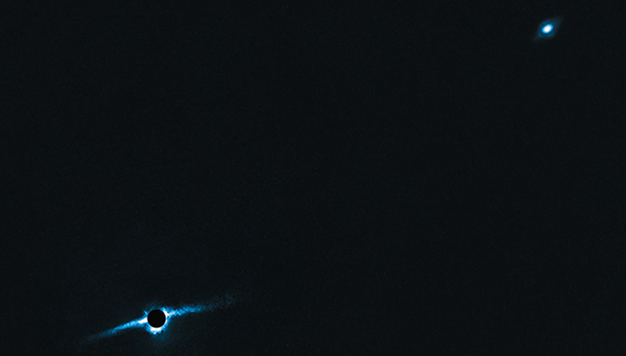 Strange planets seen in deep space, illuminated with a blue glow against a dark background.