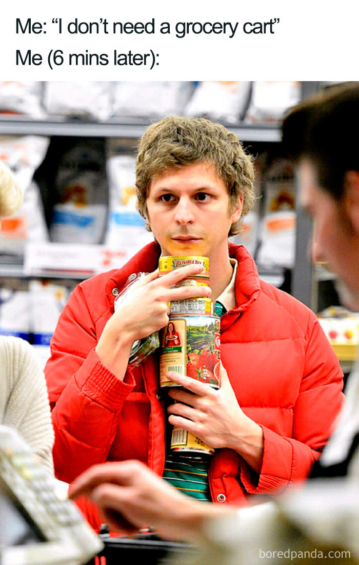 Person in a grocery store struggling to hold multiple food items, humorously illustrating a common shopping dilemma; food memes.