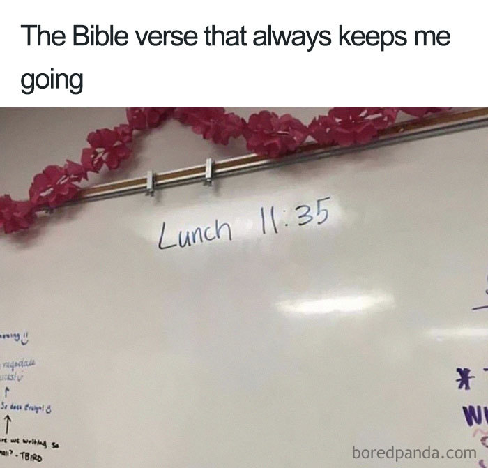 Whiteboard with "Lunch 11:35" written as a funny food meme, decorated with pink paper flowers.