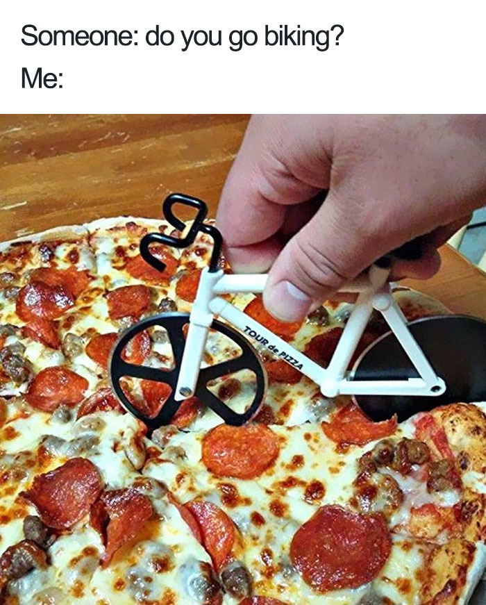 Pizza cutter shaped like a bike over a pepperoni pizza, creating a funny food meme.