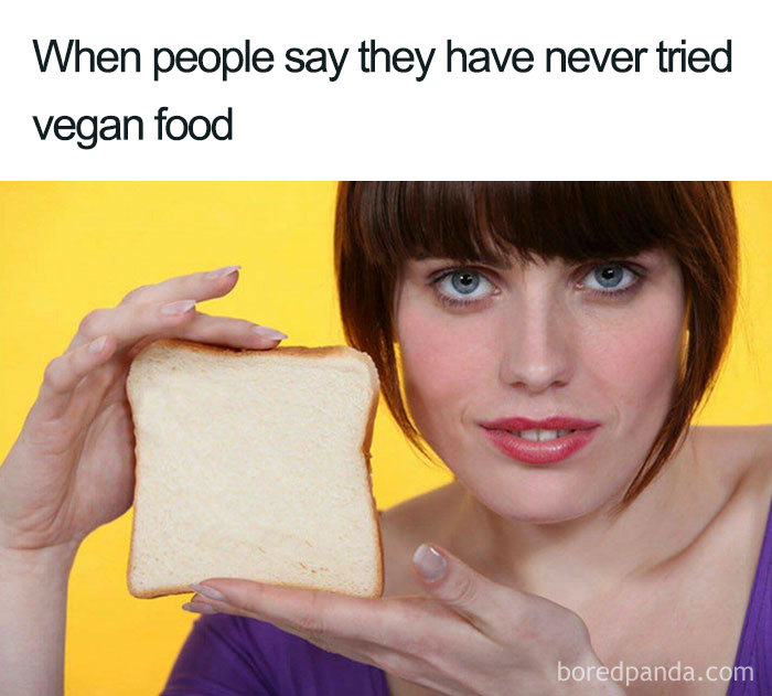 Woman holding a slice of bread with text about trying vegan food, highlighting hilarious vegan memes.