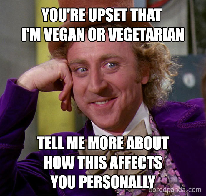 A man in a purple outfit smirking with text about being vegan or vegetarian, highlighting a vegan meme.