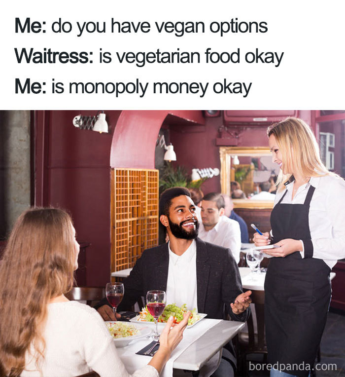 A couple in a restaurant asking a waitress for vegan options, humorously suggesting Monopoly money as payment.