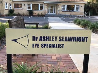Eye specialist clinic sign outside office building, showcasing humor in job fitting.