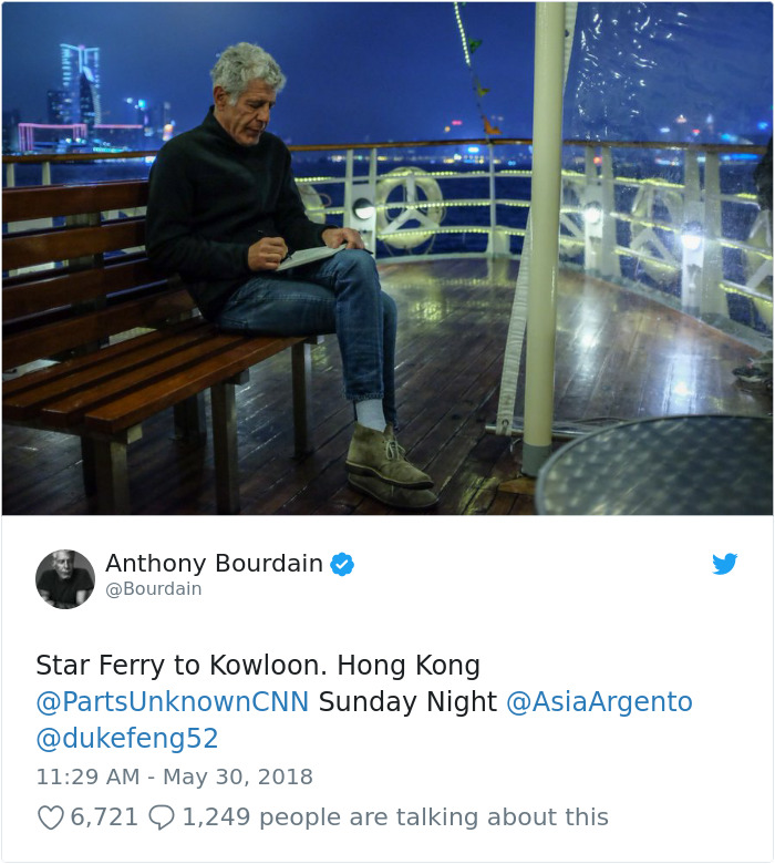 Anthony Bourdain Sitting on a bench and writing a journal 
