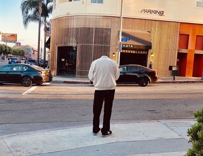 This Guy Looking Down At His Phone Looks Headless From Behind