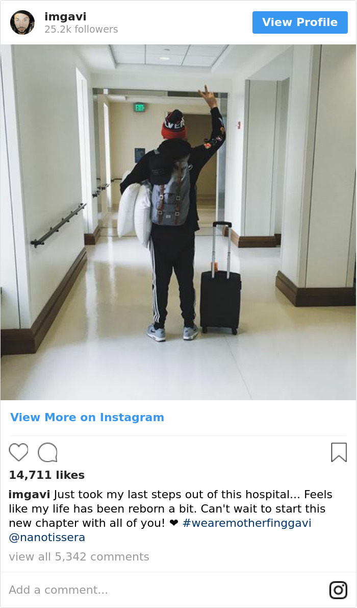 Jason Gaviati holding his hand up in a hospital's corridor 