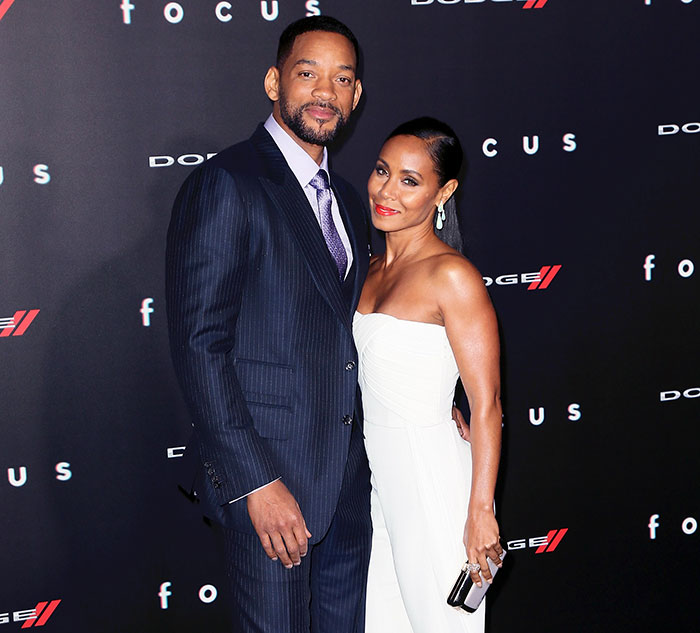 Will Smith and Jada Pinkett Smith posing together on the red carpet, representing celebrities who fell in love acting together.