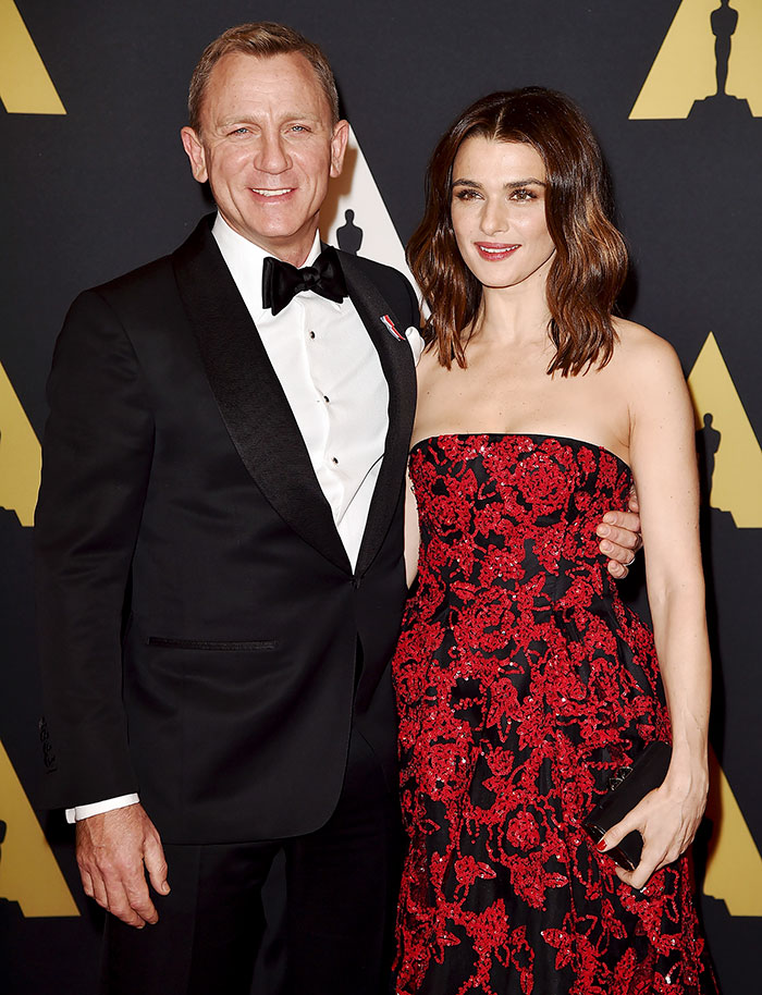 Daniel Craig and Rachel Weisz posing together at a formal event, exemplifying celebrities who fell in love while acting.