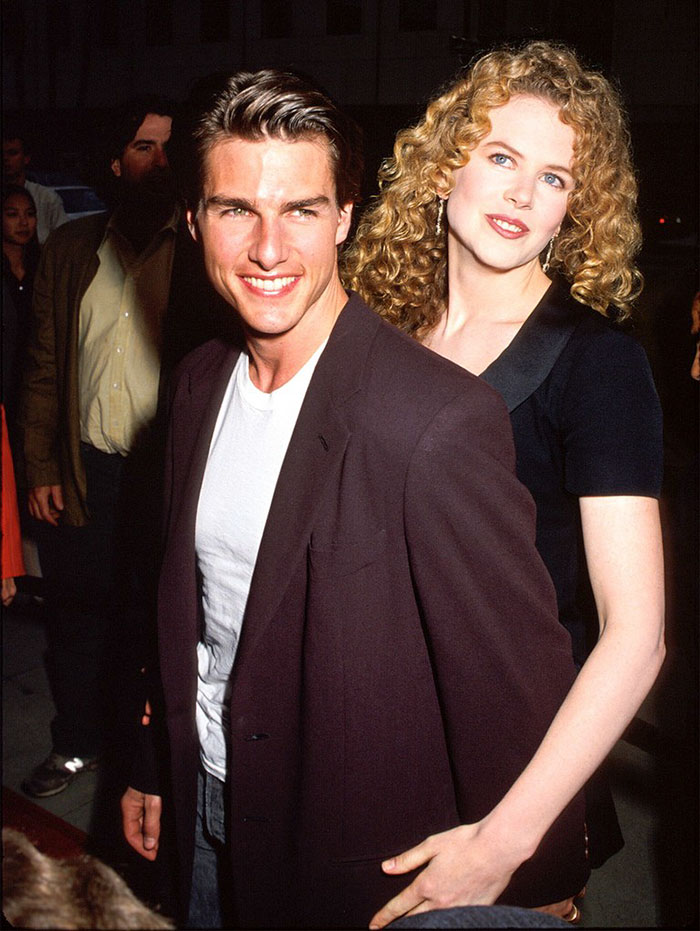 Tom Cruise and Nicole Kidman smiling together at a public event, illustrating celebrities who fell in love while acting.