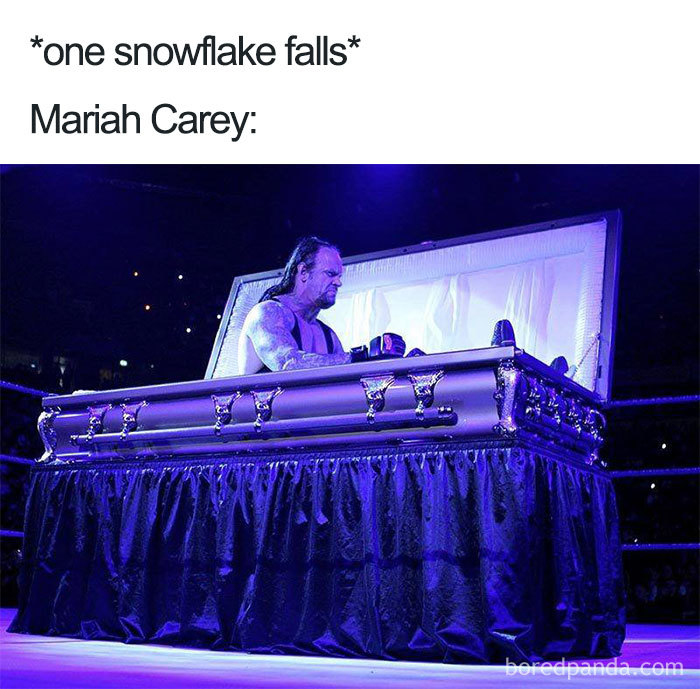 Wrestler in a coffin reacting humorously, captioned about Mariah Carey, representing hilarious Christmas memes.