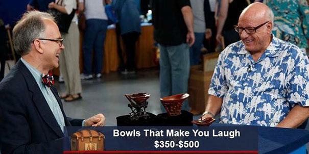 Two men on Antiques Roadshow laughing at bowls with humorous captions, valued between $350-$500.