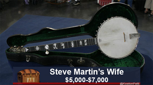 A banjo in a case labeled humorously, with caption value $5,000-$7,000, parodying Antiques Roadshow items.