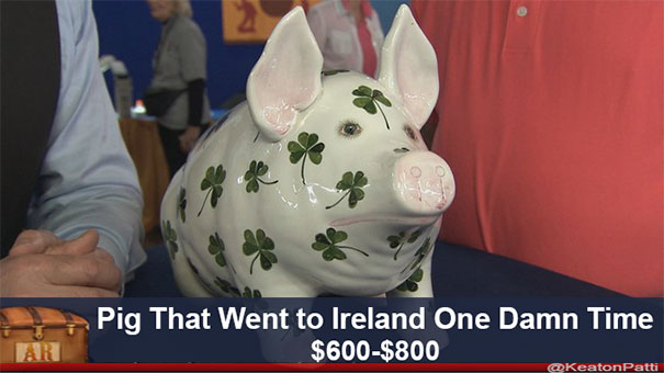 Ceramic pig with clover decorations and a funny caption on Antiques Roadshow display.