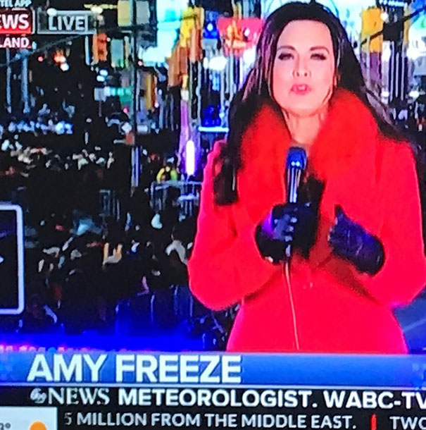 Meteorologist in a red coat reporting live, embodying a job perfectly suited for her name.