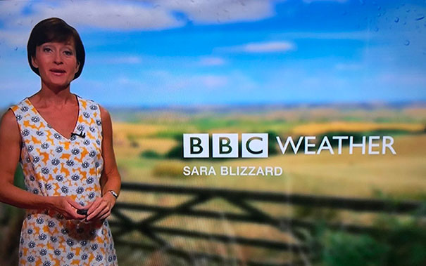 Weather presenter on BBC with countryside background, illustrating people born to do their jobs.