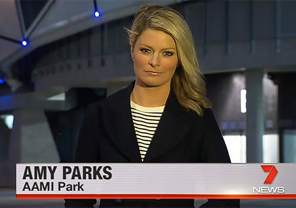 News reporter at AAMI Park delivering a segment, embodying born-to-do-their-job professionalism.