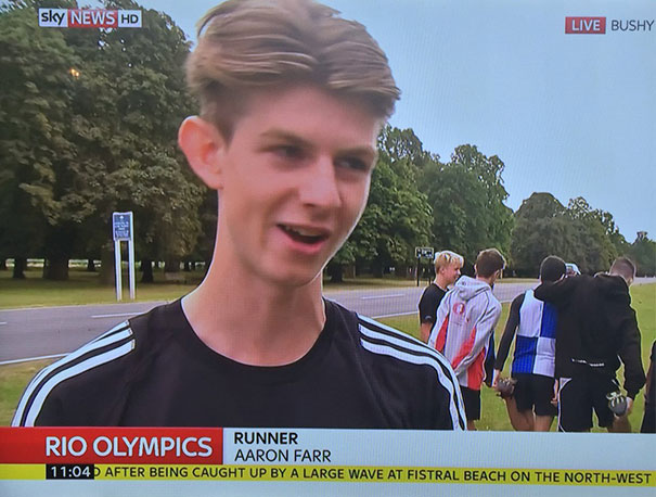 Young runner smiling during televised interview at Rio Olympics.