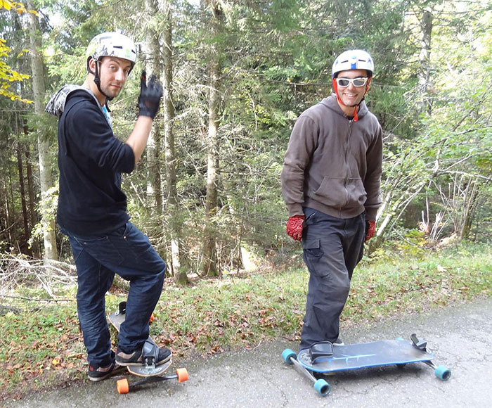 Two man with a skateboard in a forest 