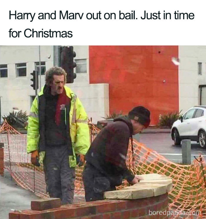 Two men resembling Harry and Marv stand by a construction site in a humorous Christmas meme.