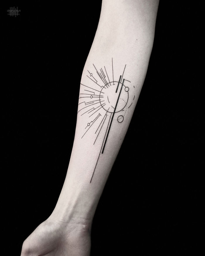Geometric tattoo on forearm with intricate lines and circles, designed by Turkish artist Okan Uçkun.