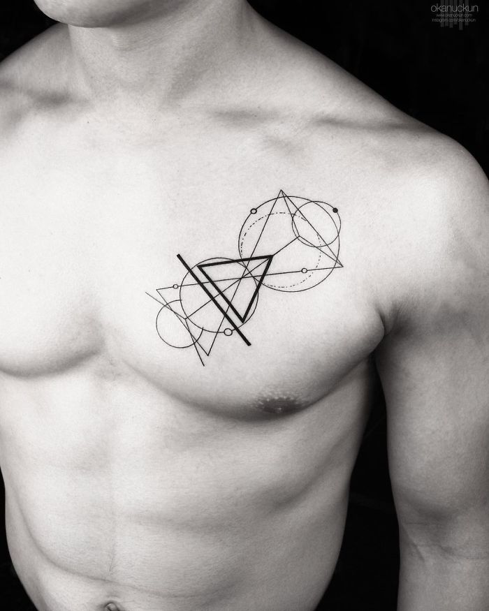 Geometric tattoo by Turkish artist Okan Uçkun on a man's chest, featuring intersecting circles and lines.