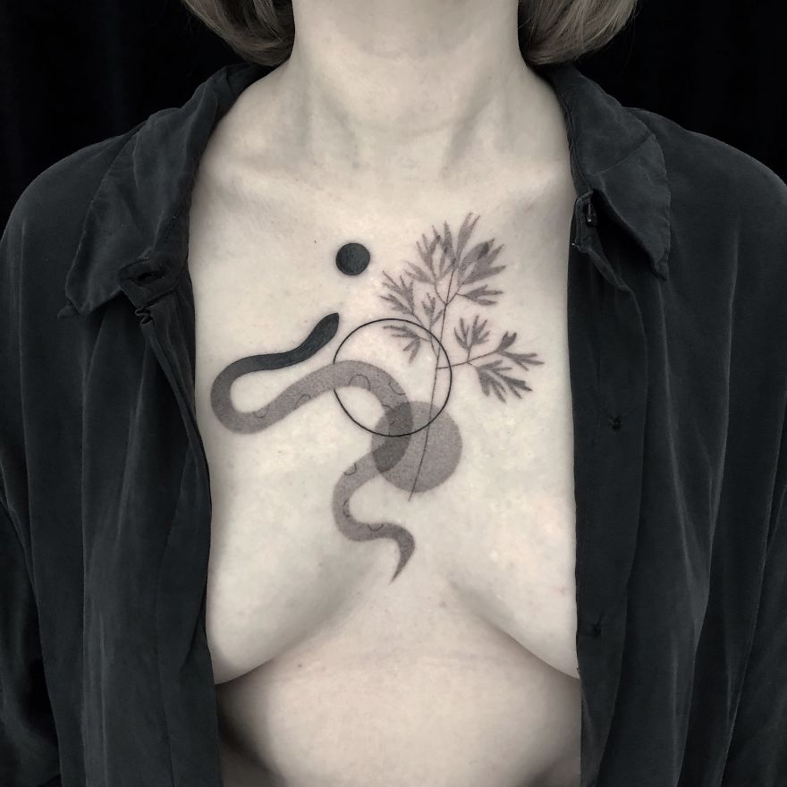 Minimalism and botanical tattoo design featuring geometric shapes and plant elements on a person's chest.