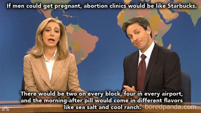 Two people on a comedy show set discussing feminist memes with a humorous caption about pregnancy and societal norms.