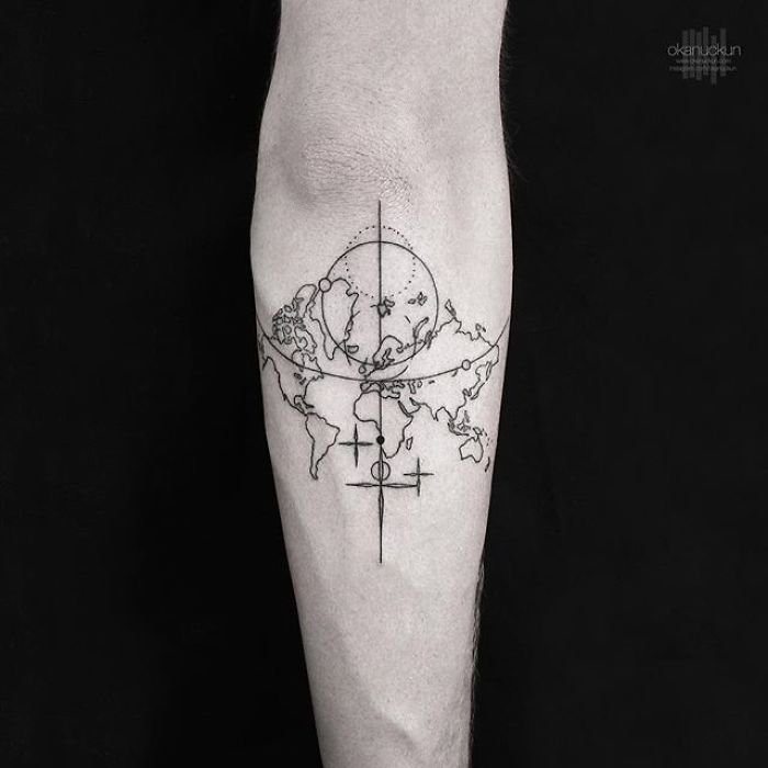 Geometric tattoo of a world map on a forearm by Turkish artist Okan Uçkun.
