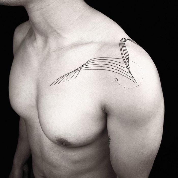 Geometric tattoos by Turkish artist, featuring a minimalist shoulder design.