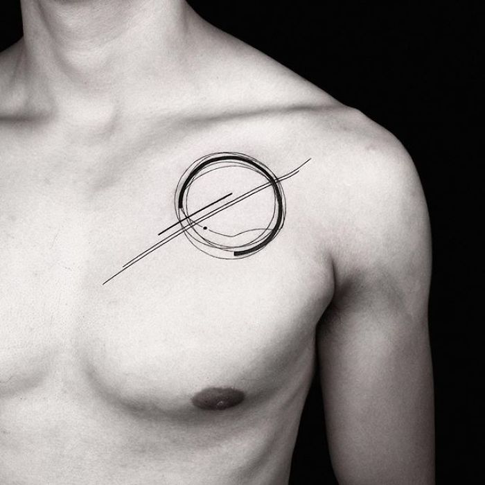 Geometric tattoo on a person's chest, featuring intricate lines and shapes by Turkish artist Okan Uçkun.