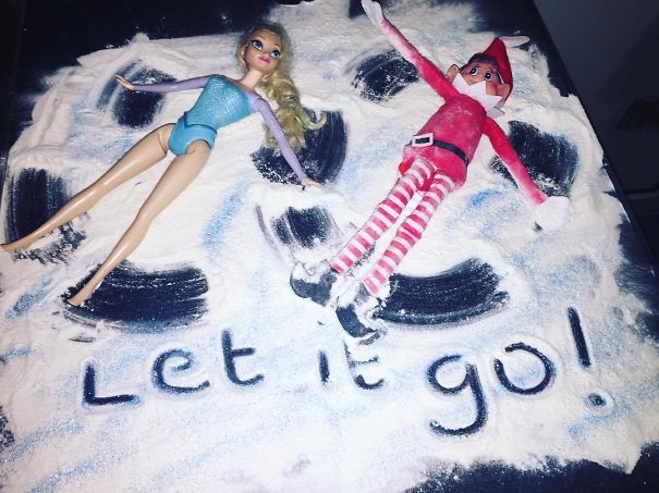 "Elf On The Shelf idea featuring the elf and a doll resembling Elsa from Frozen making 'snow angels' in flour with the words 'Let it go!' written below."