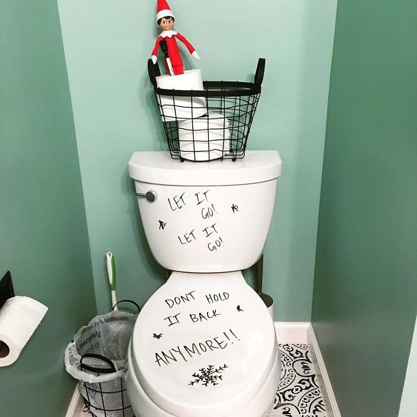 "Elf On The Shelf idea with the elf on a toilet tank, next to 'Let it go! Don't hold it back anymore!' written on the toilet in a Frozen theme."