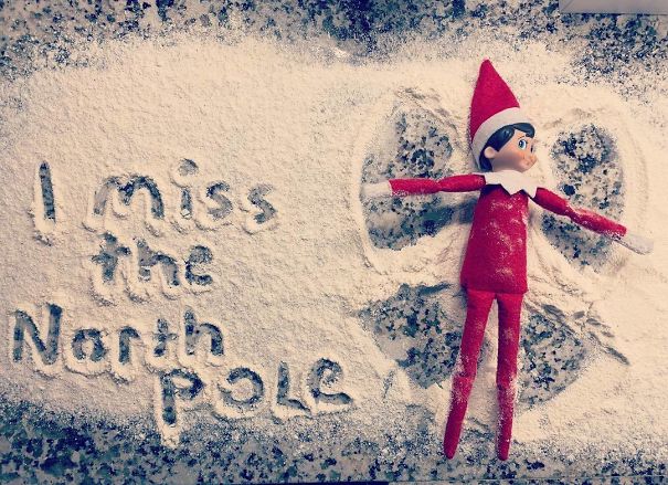 "Elf On The Shelf idea with the elf making a snow angel in flour, next to the words 'I miss the North Pole' written in the flour."