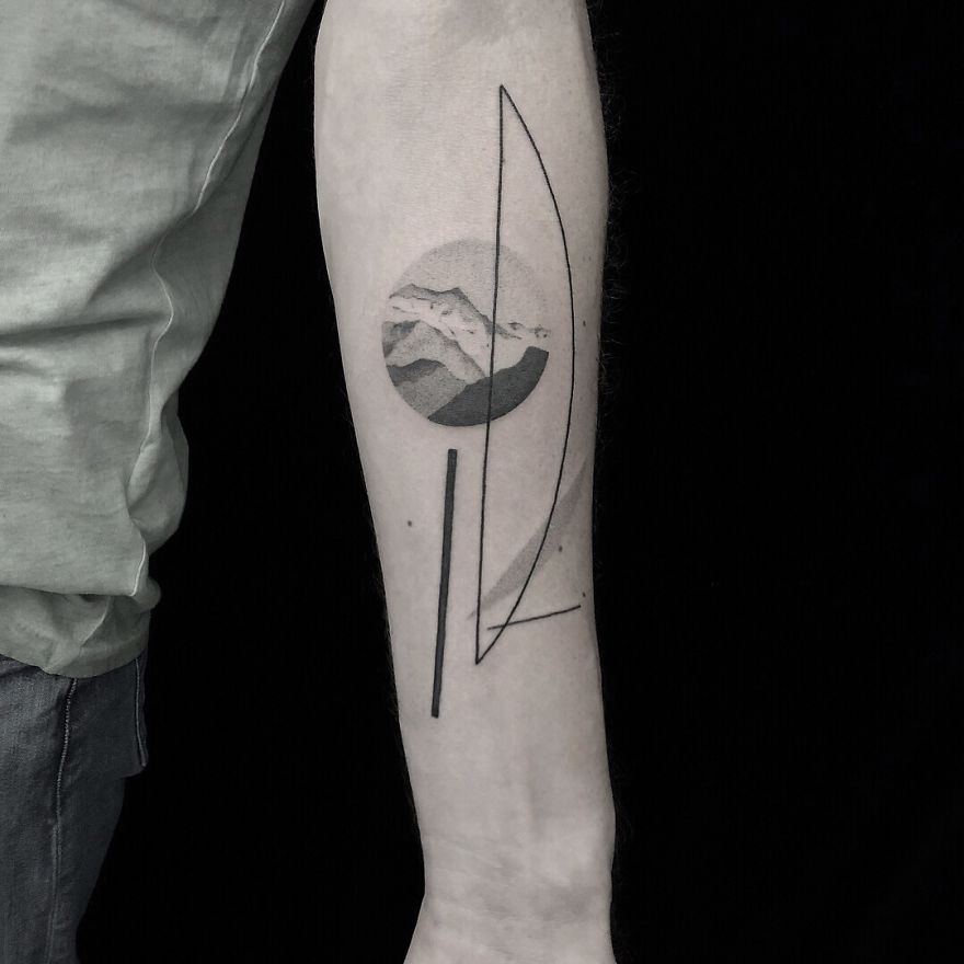 Minimalist tattoo with botanical and geometric design on forearm.