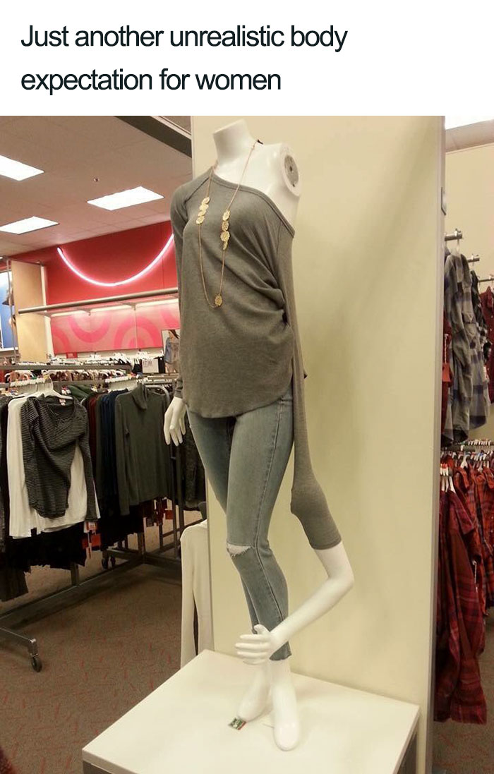 Mannequin with unrealistic proportions in jeans and gray top highlights feminist humor on body expectations.