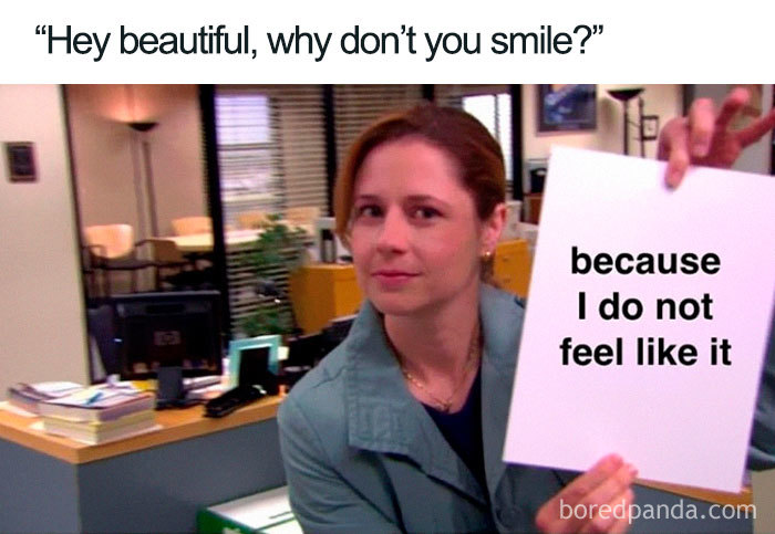 Woman holding a sign responding humorously to a compliment, highlighting feminist perspectives.