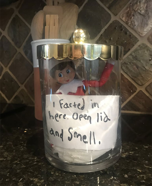 "Elf On The Shelf idea with the elf inside a glass jar, next to a note saying, 'I farted in here. Open lid and smell,' creating a playful prank."
