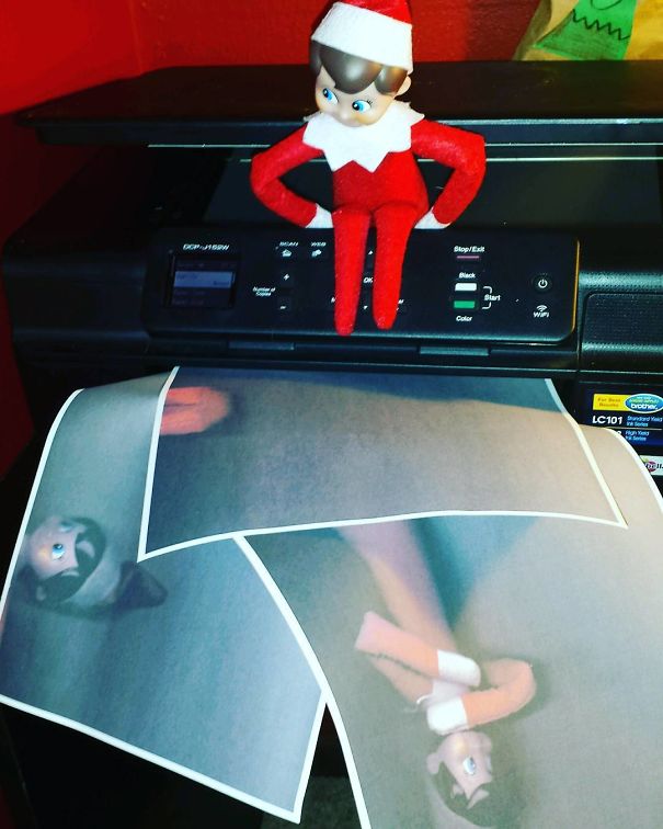 "Elf On The Shelf idea with the elf sitting on a printer, producing enlarged and funny copies of its own face on the printed pages."