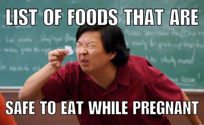 Person squinting at a tiny paper titled "List of foods safe to eat while pregnant," a humorous pregnancy meme.
