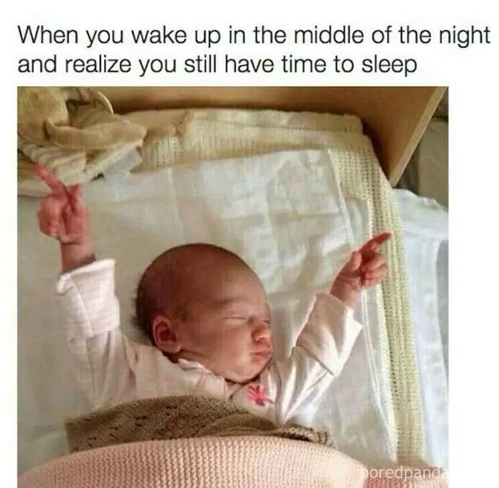 Baby sleeping peacefully with raised arms, capturing a funny sleeping meme moment.