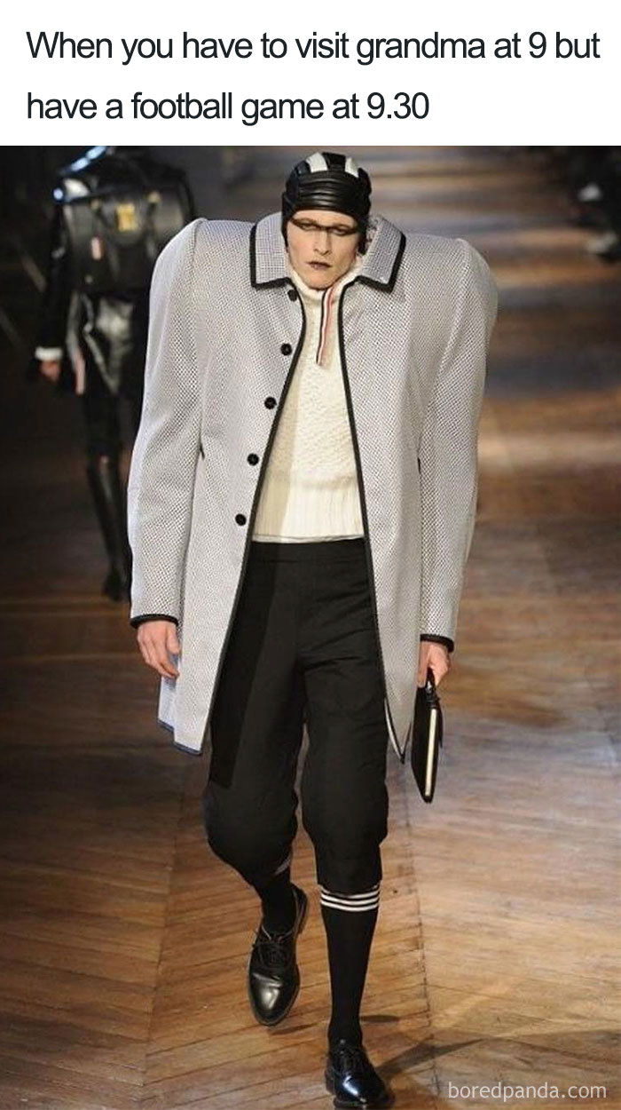 Model in oversized shoulder outfit, blending fashion disasters with humor on runway.