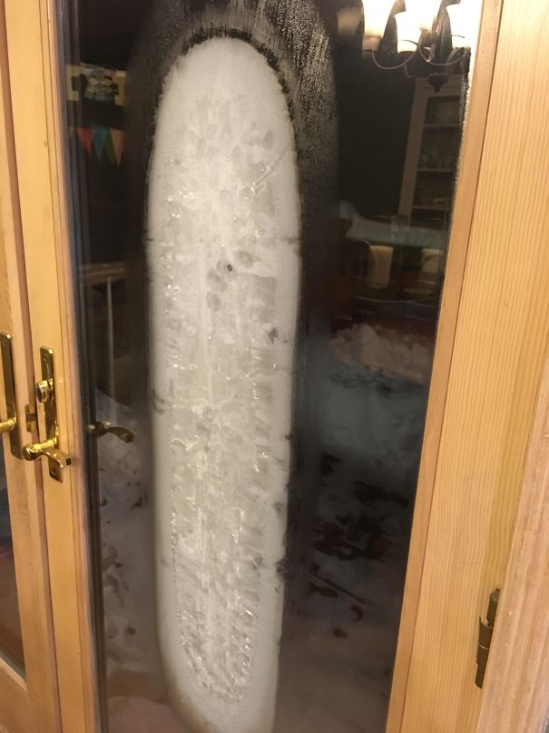 A Sheet Of Ice Formed Between The Glass Panes Of This Door