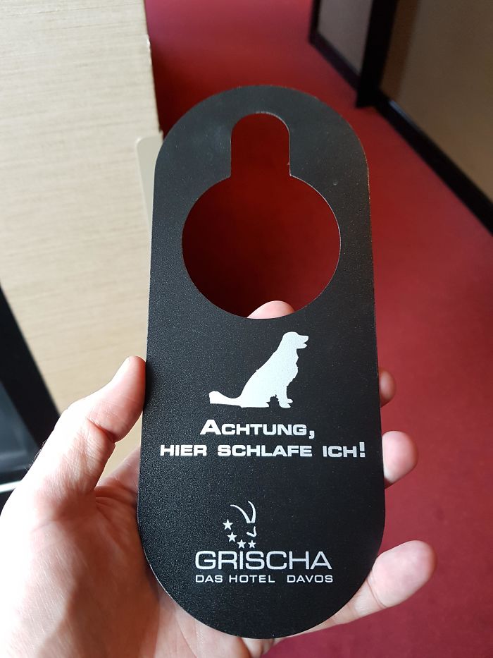 This Hotel Allows Dogs And You Can Alert The Cleaners That You Left Your Dog In The Room While You Ski (Translation: Attention, I Am Sleeping Here!)