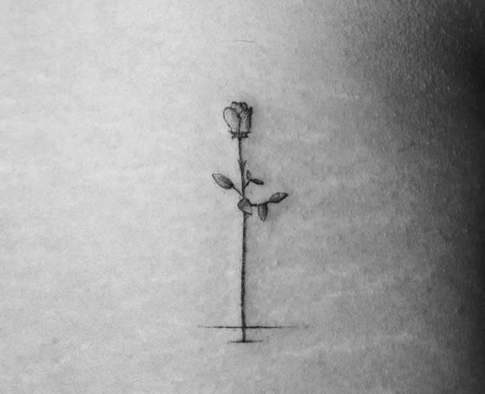 Minimalist rose tattoo on skin, part of an artist's motion tattoo project involving 70 strangers with different frames. Minimalist rose tattoo on skin, part of an artist's motion tattoo project involving 70 strangers with different frames.