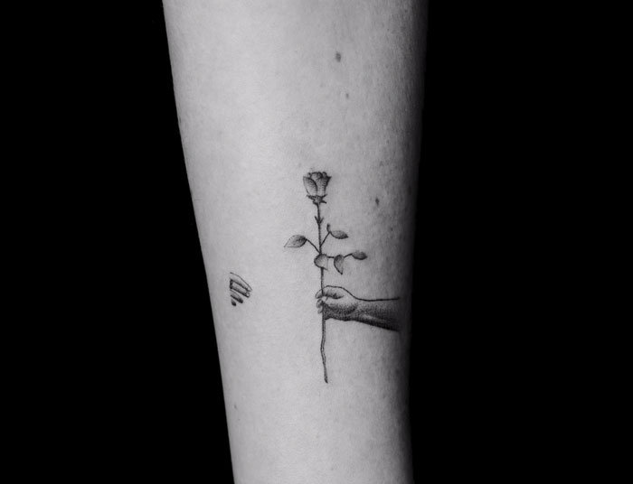 Tattoo showing a hand holding a rose, part of an artist's motion tattoo project on 70 strangers. Tattoo showing a hand holding a rose, part of an artist's motion tattoo project on 70 strangers.