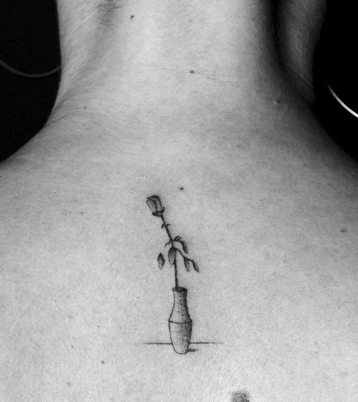 A tattoo of a rose in a vase on skin, part of a series of motion tattoos by an artist inking strangers. A tattoo of a rose in a vase on skin, part of a series of motion tattoos by an artist inking strangers.