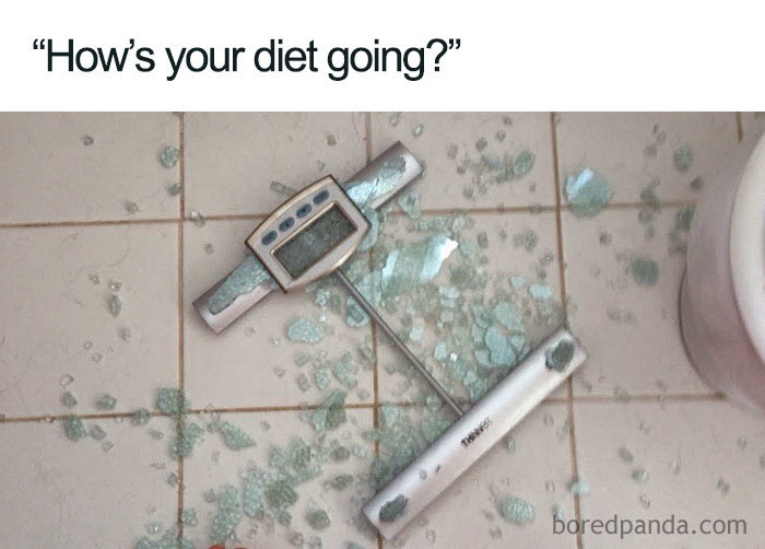 Broken scale pieces on a tiled floor, humorously illustrating weight loss and diet struggles.