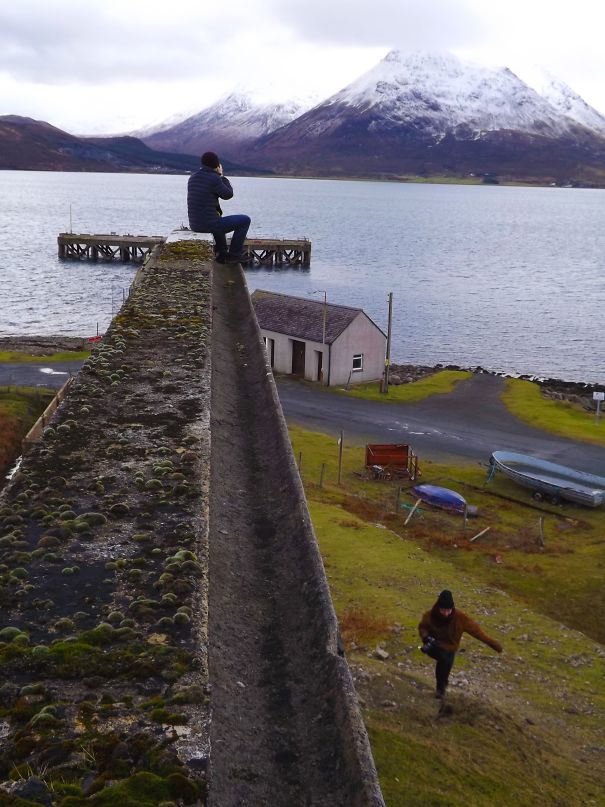 My Friend Took A Photo Of Me Sitting On A Wall That Ended Up Looking Like A Giant Sitting On The End Of A Pier